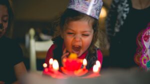 Child blowing out birthday candles