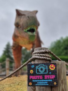 photo stop sign with t rex behind