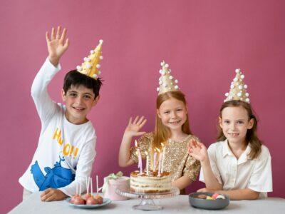 Kids waving at the camera during a birthday party