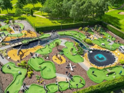 Aerial drone view of the full Wolverhampton Adventure Golf course showing all 18 holes, water features and dinosaur figures