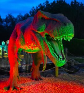 Glow-in-the-dark T-Rex dinosaur lit with green and red LED lights at Wolverhampton Adventure Golf