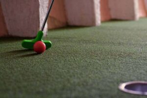 Putting green and club on the dinosaur adventure golf course